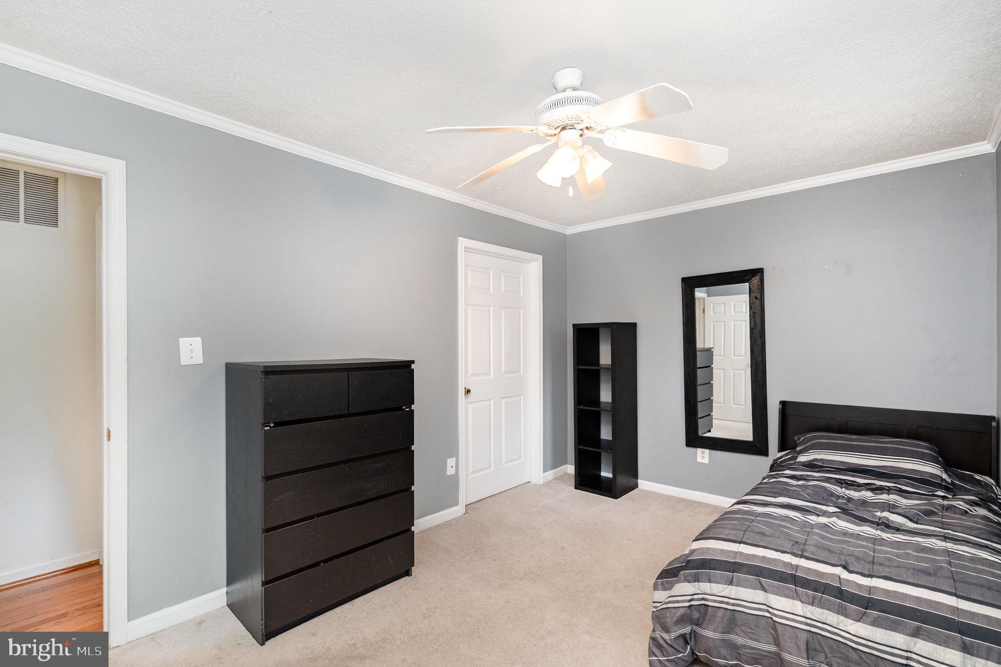 4530 Rincon Place Dumfries, VA 22025 - Photo 27 of 45 a bedroom with a bed and a chandelier