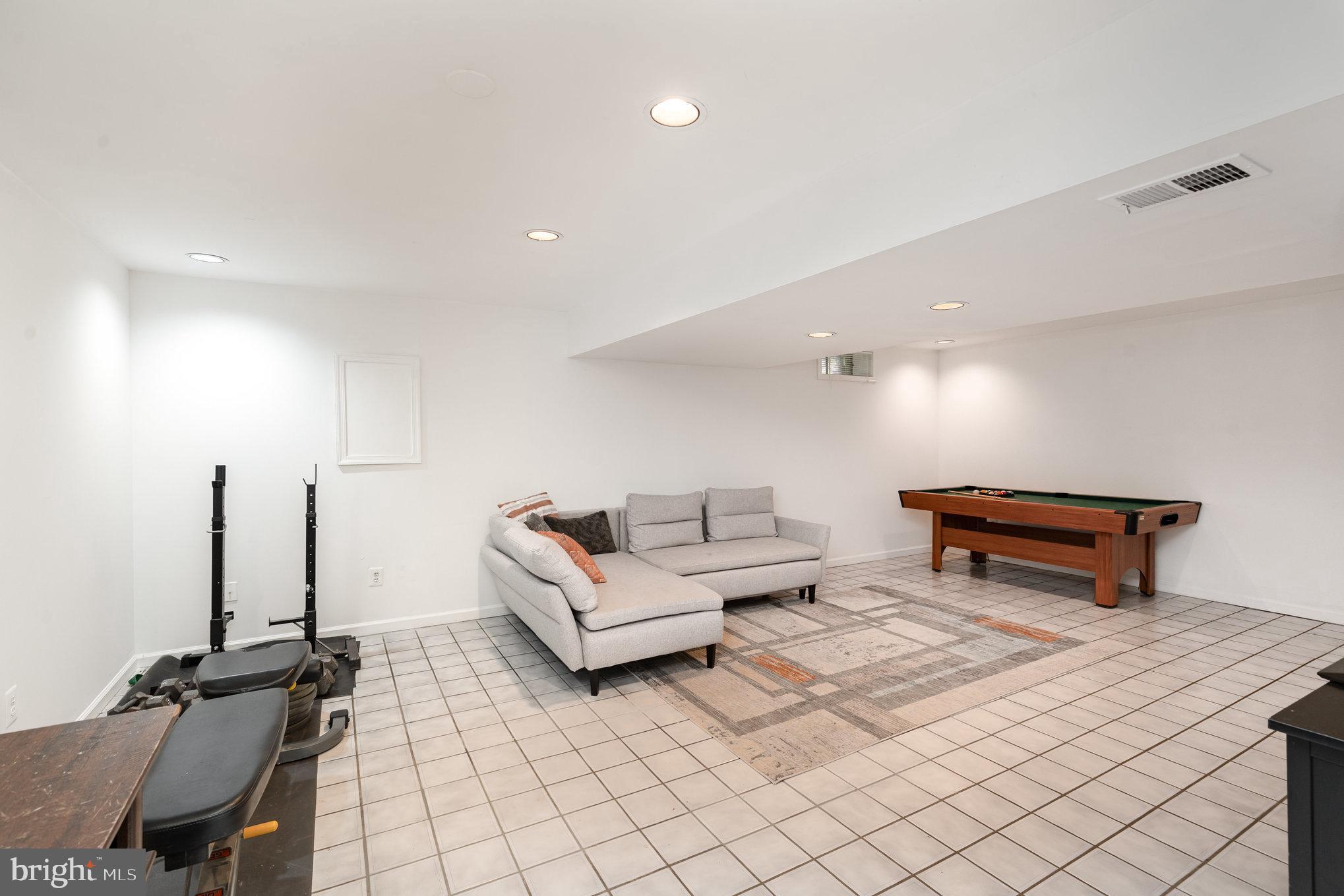 4530 Rincon Place Dumfries, VA 22025 - Photo 33 of 45 a living room with furniture and a table