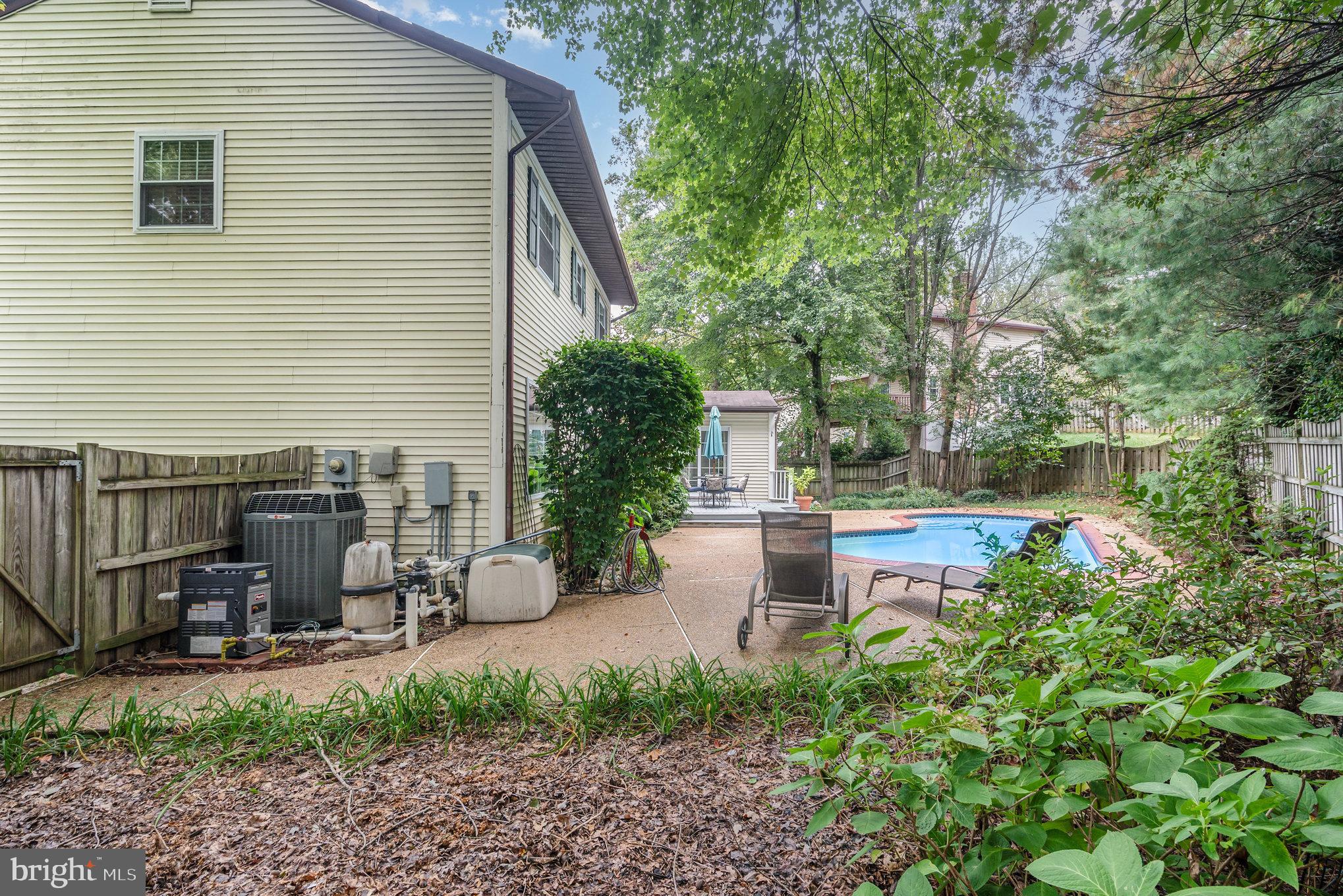 4530 Rincon Place Dumfries, VA 22025 - Photo 44 of 45 a view of a patio with table and chairs potted plants and large tree