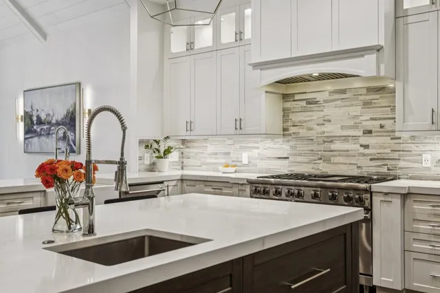a kitchen with a stove sink and cabinets
