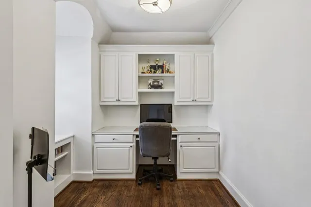 a view of a bedroom with wooden floor and window