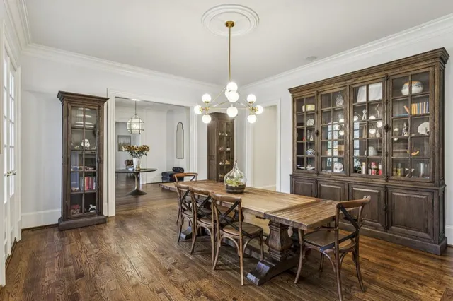 a living room with furniture a fireplace and a large window
