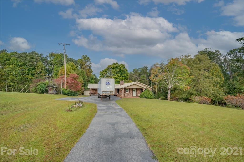 4771 Highway 9 Mill Spring, NC 28756 - Photo 1 of 35 a view of a swimming pool and trees in the background