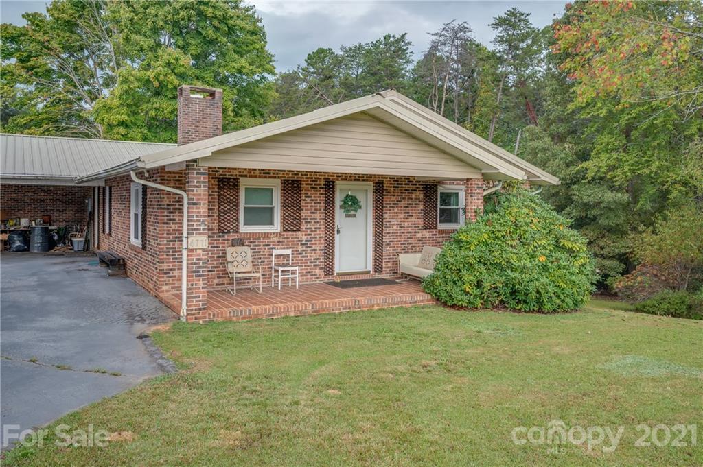 4771 Highway 9 Mill Spring, NC 28756 - Photo 2 of 35 a front view of a house with yard and green space
