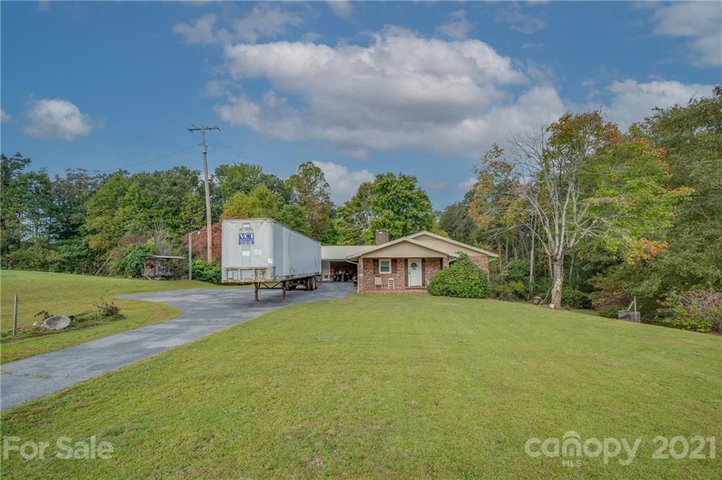 4771 Highway 9 Mill Spring, NC 28756 - Photo 35 of 35 a view of a house with a yard and large trees