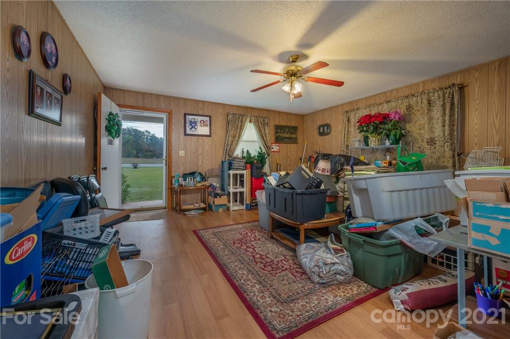 4771 Highway 9 Mill Spring, NC 28756 - Photo 6 of 35 a living room with lots of furniture and a chandelier