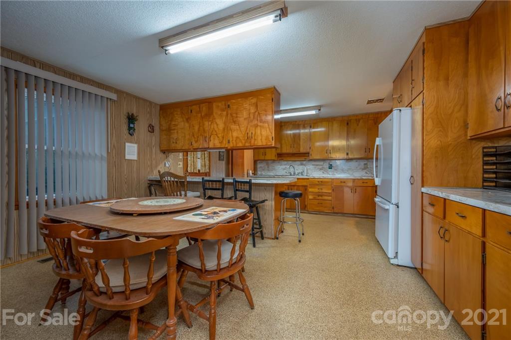 4771 Highway 9 Mill Spring, NC 28756 - Photo 7 of 35 a dining room with stainless steel appliances kitchen island granite countertop furniture and a kitchen view