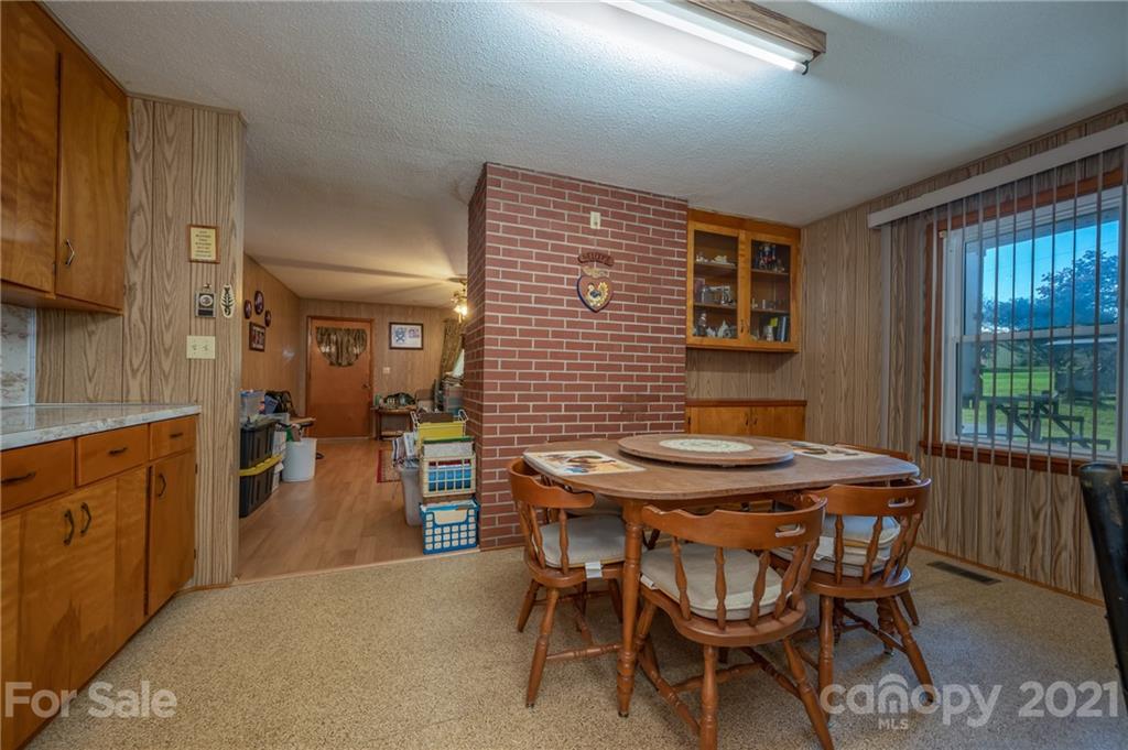 4771 Highway 9 Mill Spring, NC 28756 - Photo 8 of 35 a dining room with furniture and window