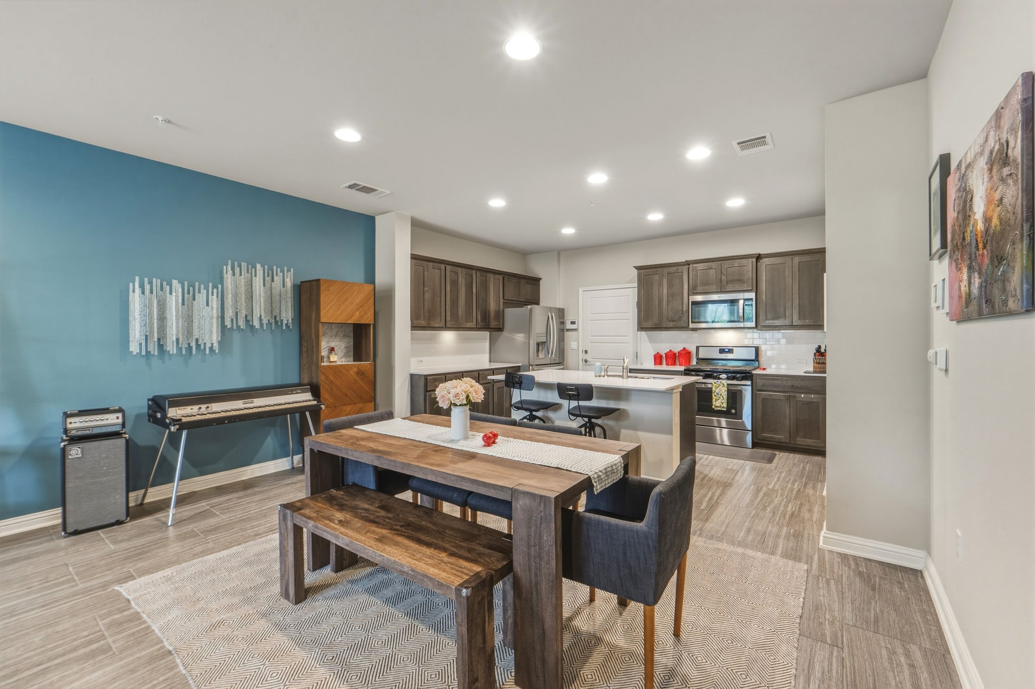 6814 East Riverside Drive, Unit 34 Austin, TX 78741 - Photo 6 of 26 a kitchen with a refrigerator a stove top oven a sink dishwasher and white cabinets with wooden floor