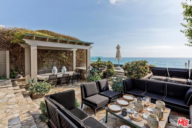 a outdoor living space with furniture and a fireplace