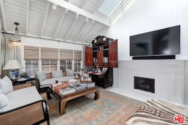 a living room with fireplace furniture and a flat screen tv
