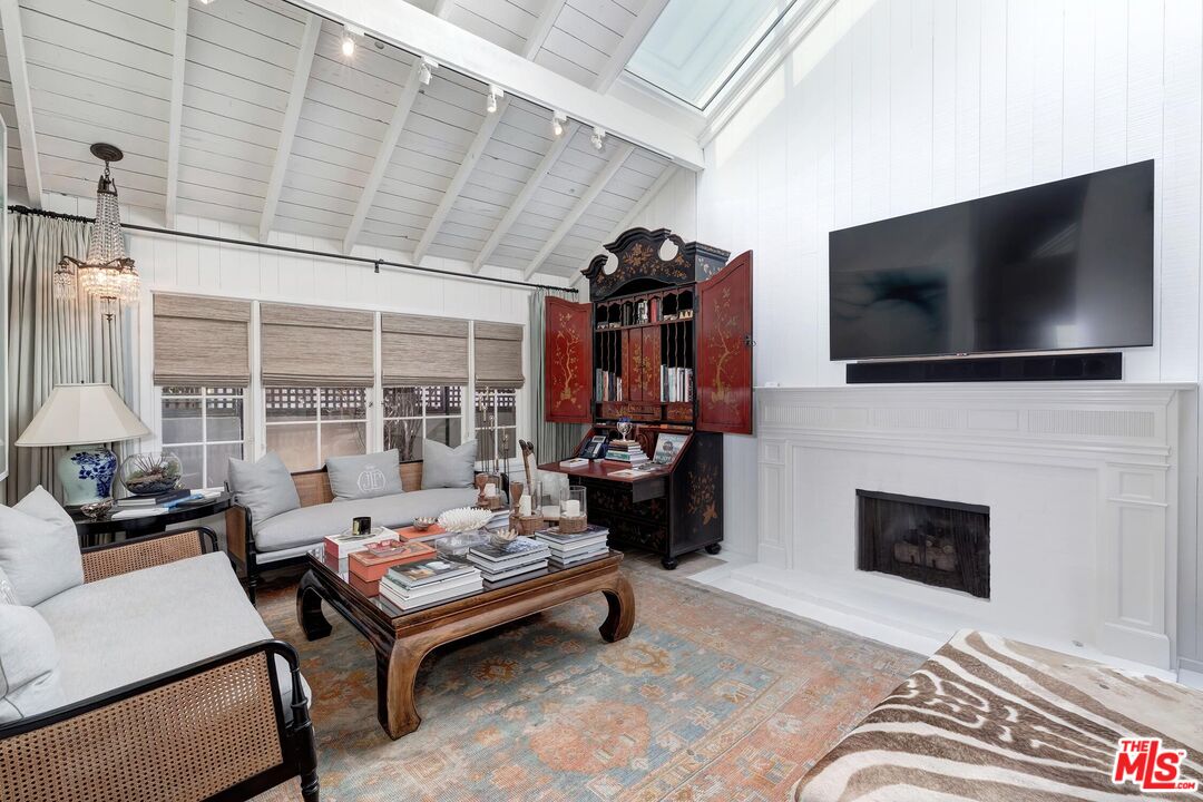 23618 Malibu Colony Road, Unit 56 Malibu, CA 90265 - Photo 17 of 29 a living room with fireplace furniture and a flat screen tv
