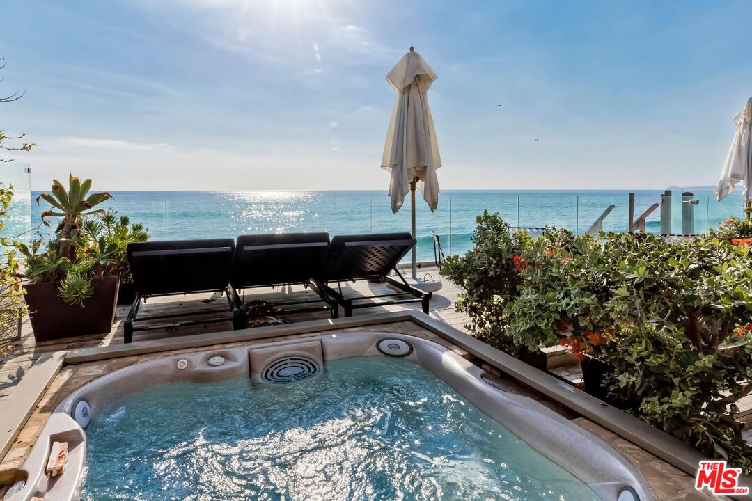 23618 Malibu Colony Road, Unit 56 Malibu, CA 90265 - Photo 22 of 29 a view of a terrace with a bench