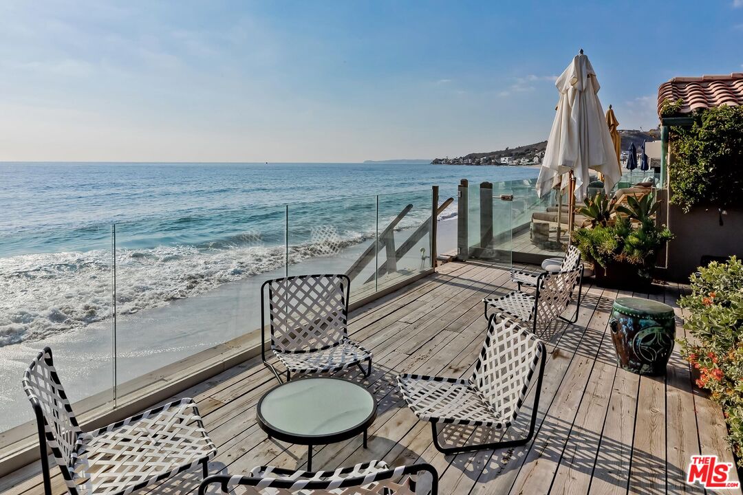 23618 Malibu Colony Road, Unit 56 Malibu, CA 90265 - Photo 24 of 29 a balcony with table and chairs