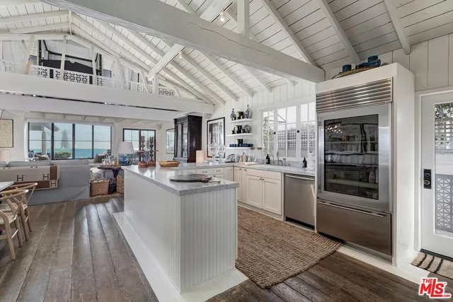 a kitchen with sink cabinets and stove top oven