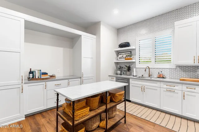 a kitchen with a sink cabinets and window