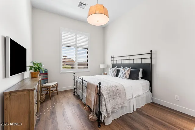 a bedroom with a bed and a chandelier
