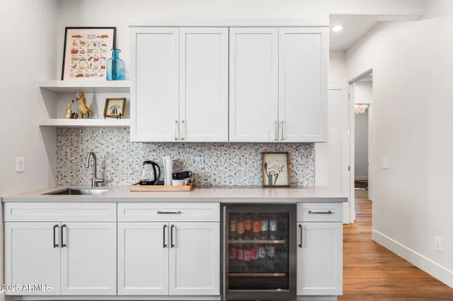 a kitchen with stainless steel appliances granite countertop a sink and a white cabinets
