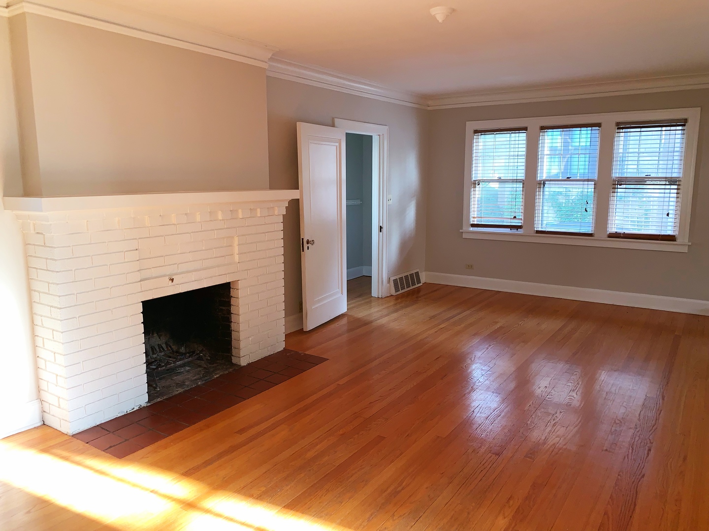 161 E Road Glen Ellyn, IL 60137 - Photo 2 of 13 a view of an empty room with wooden floor fireplace and a window