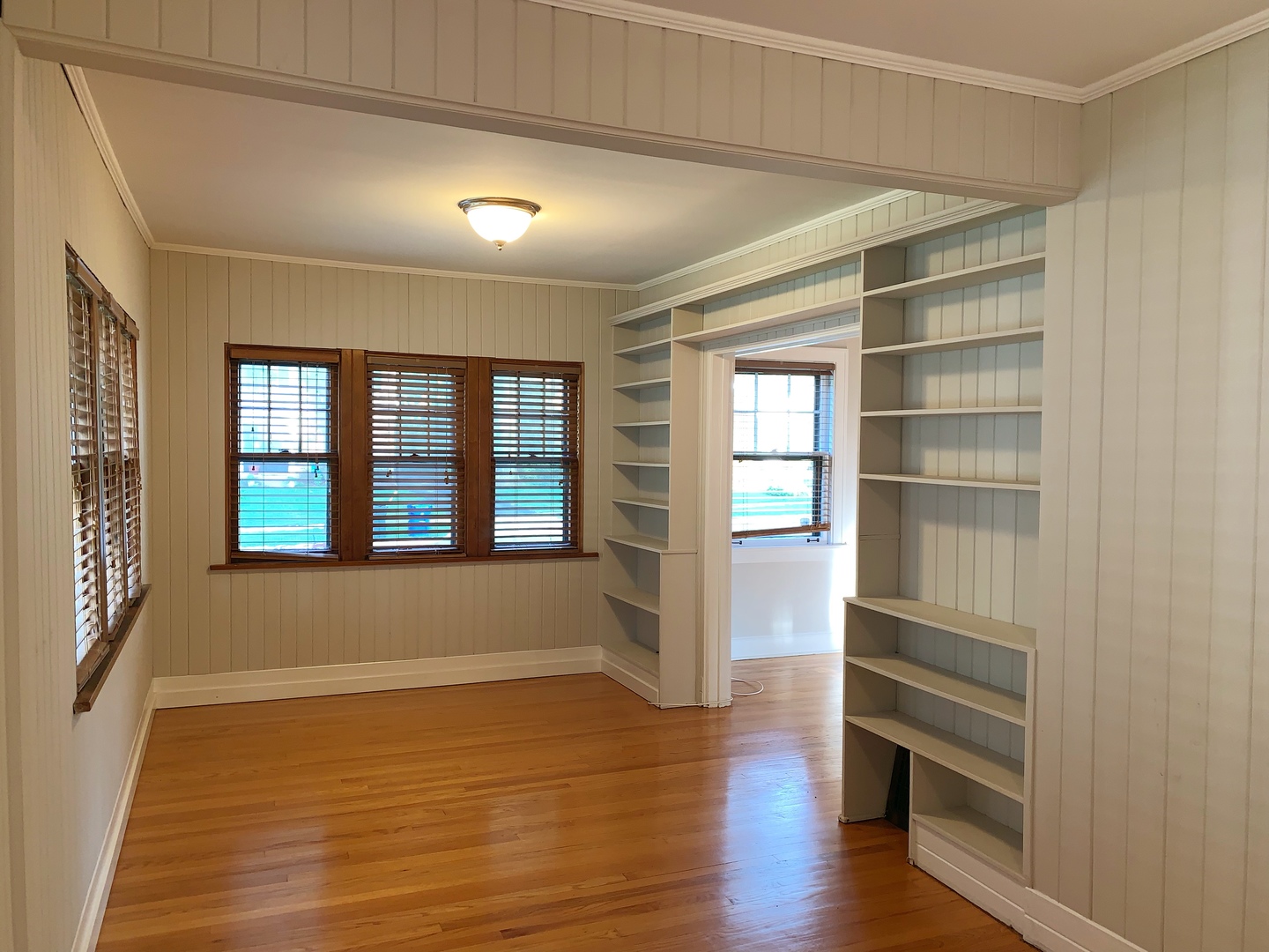 161 E Road Glen Ellyn, IL 60137 - Photo 5 of 13 a view of an empty room with a window and wooden floor