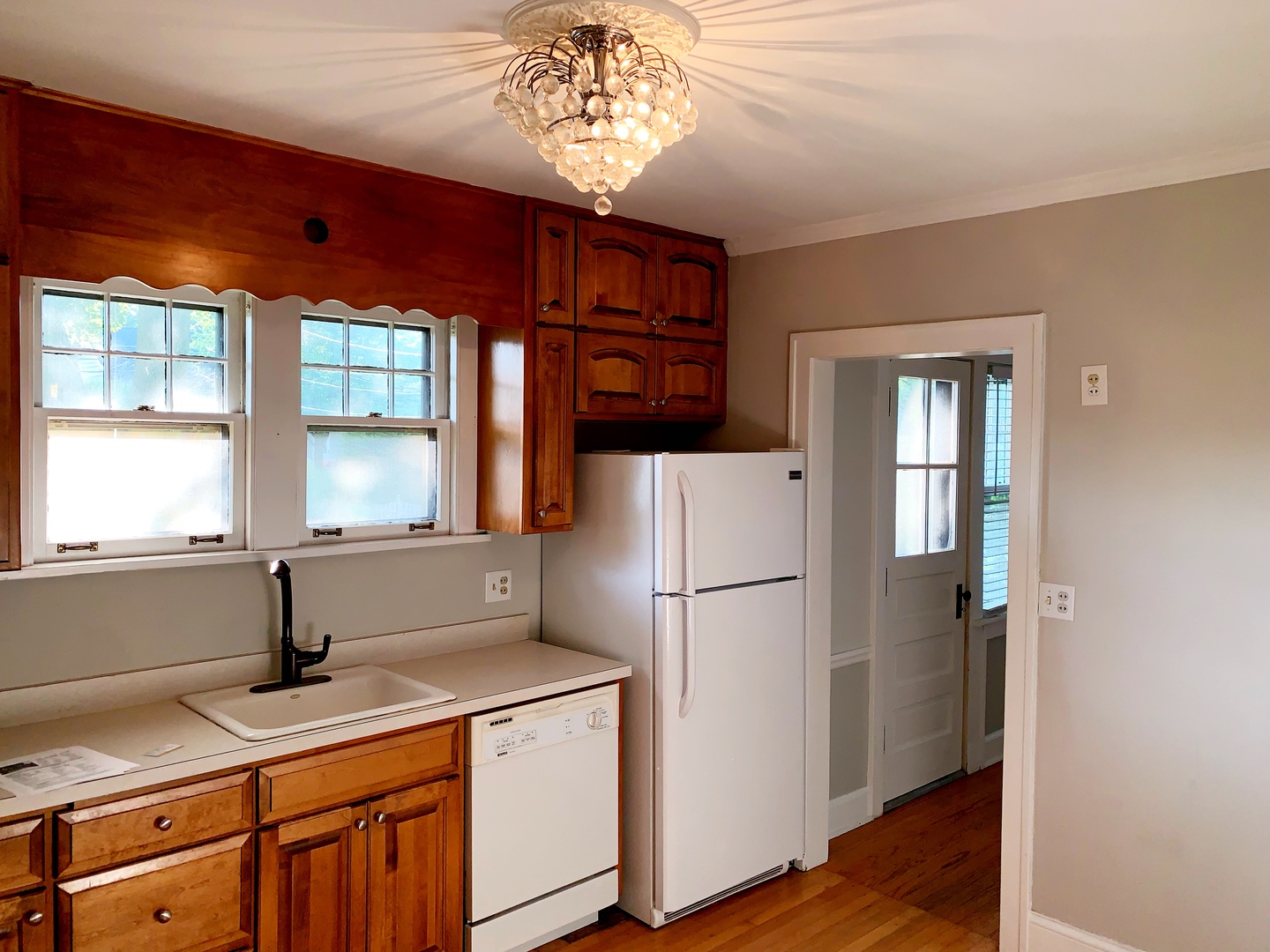 161 E Road Glen Ellyn, IL 60137 - Photo 7 of 13 a kitchen with a refrigerator a sink and dishwasher with wooden floor