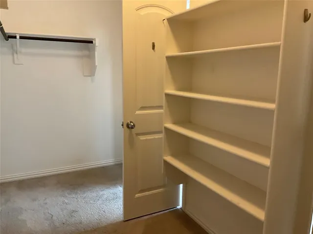 a white toilet sitting next to a shower