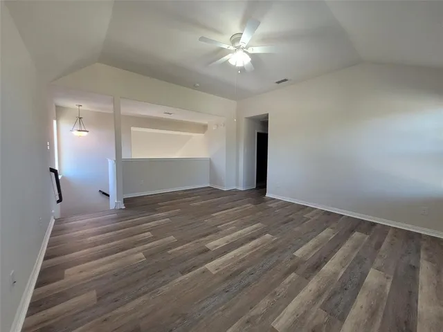 a view of staircase with lots of frames on wall and a window