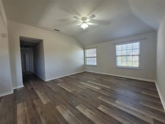 a view of a garden with a wooden fence
