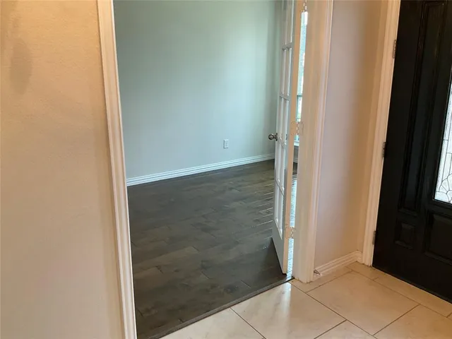 a kitchen with granite countertop a refrigerator and a sink