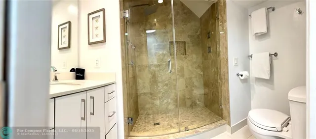 a bedroom with a bed and a flat screen tv in white walls