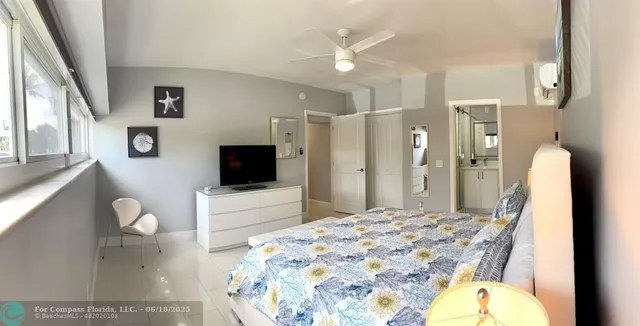 a bedroom with a bed lamp and a window