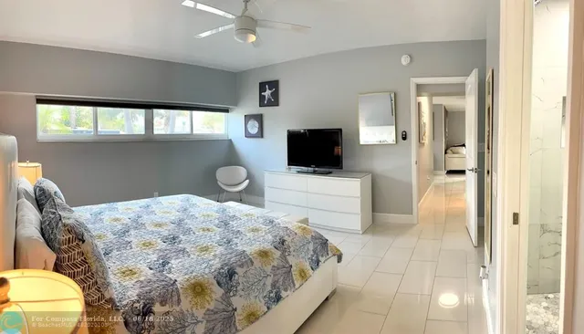 a bathroom with a granite countertop toilet sink and mirror