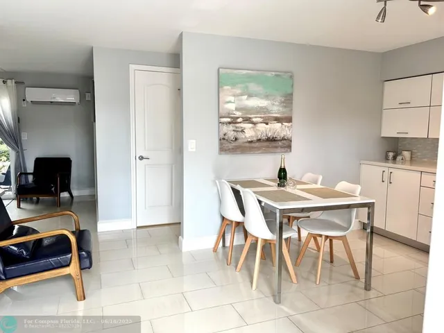 a view of a dining room with furniture and a window