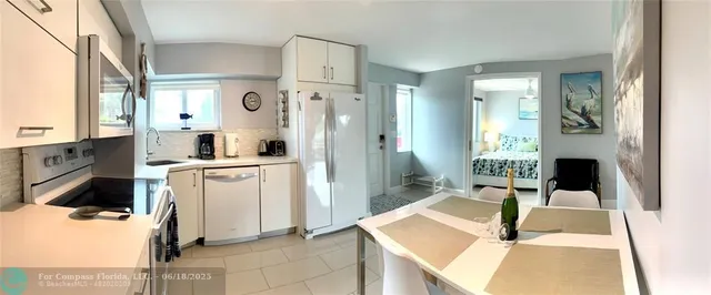 a living room with furniture a fireplace a flat screen tv and a table