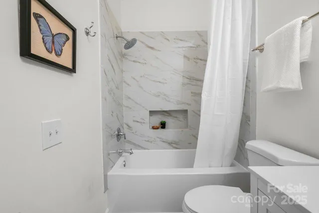 a bathroom with a toilet and a bathtub