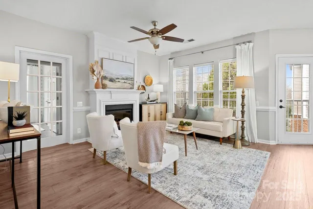 a living room with furniture a fireplace and a table