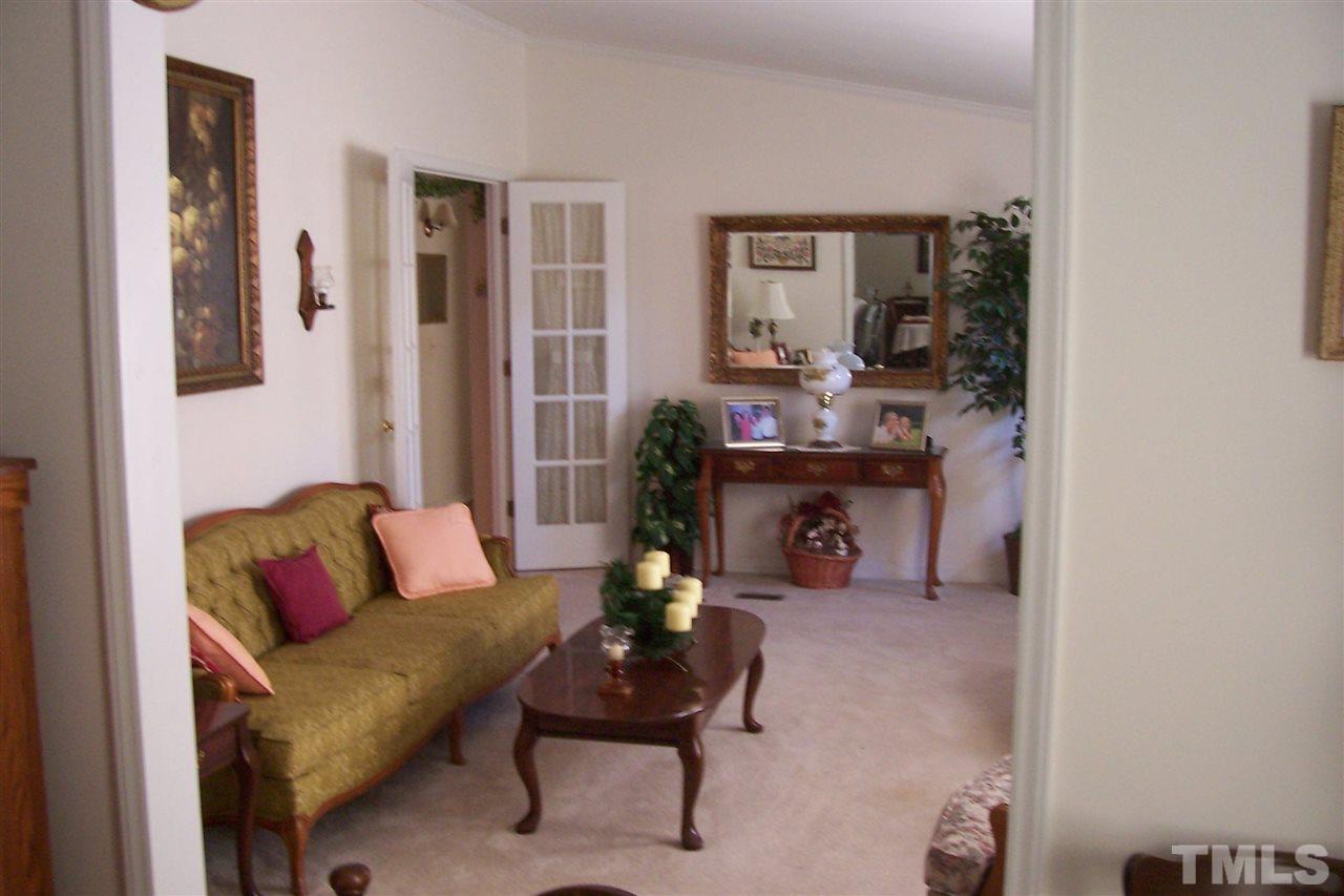 371 Lipscomb Road Angier, NC 27501 - Photo 2 of 9 a living room with furniture and a fireplace