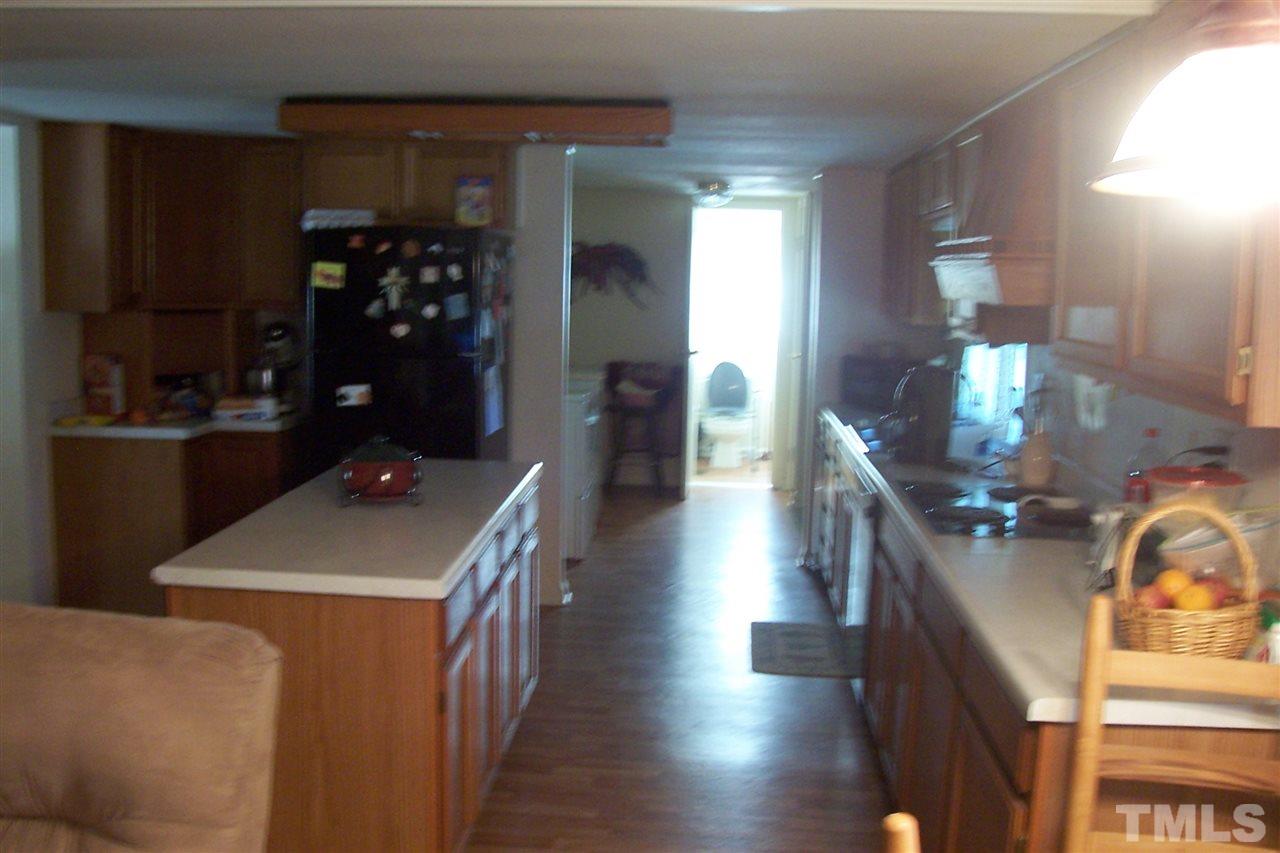 371 Lipscomb Road Angier, NC 27501 - Photo 3 of 9 a kitchen with counter top space and wooden floor