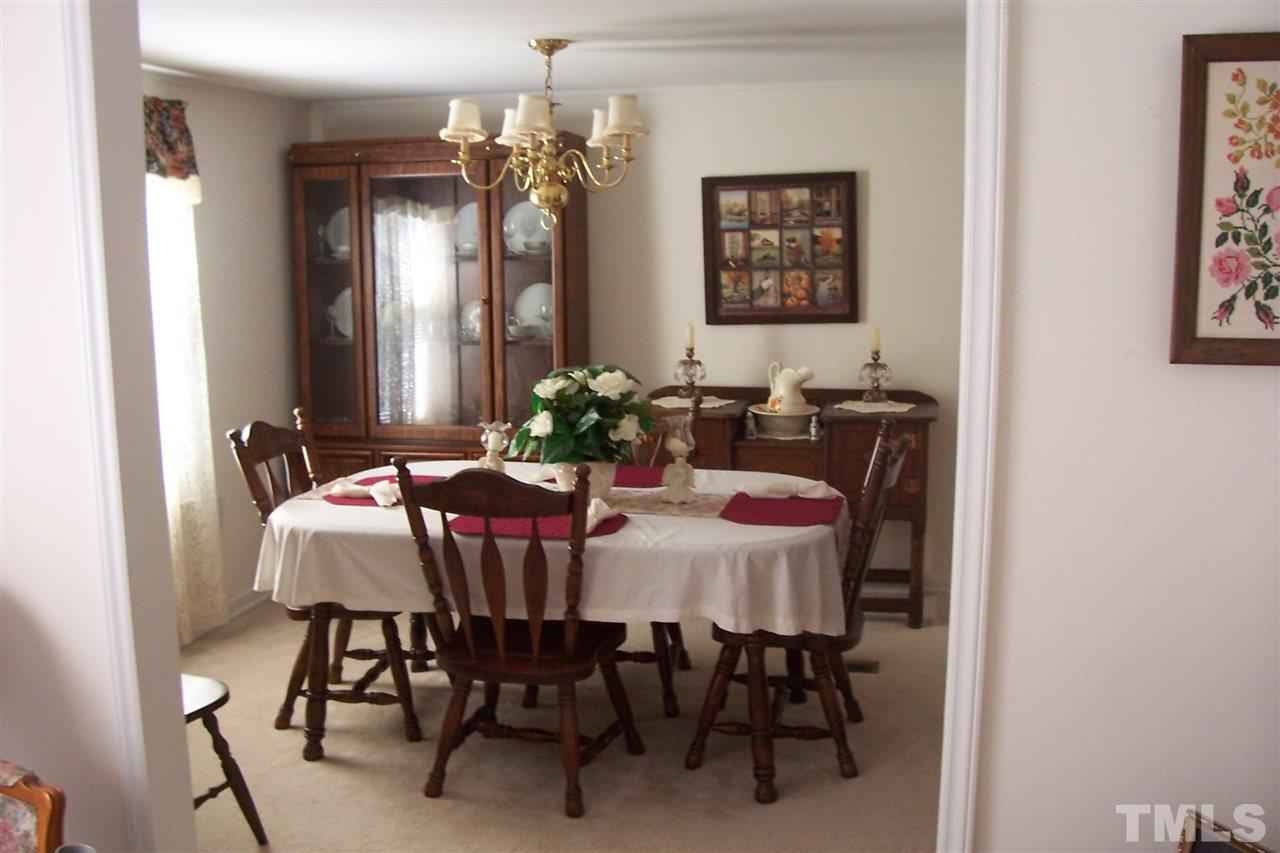 371 Lipscomb Road Angier, NC 27501 - Photo 4 of 9 a view of a dining room with furniture and chandelier