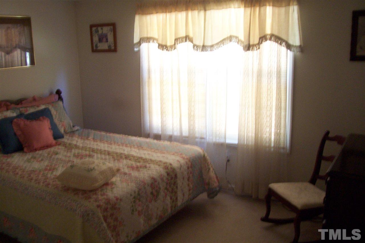 371 Lipscomb Road Angier, NC 27501 - Photo 5 of 9 a bedroom with a bed and a window
