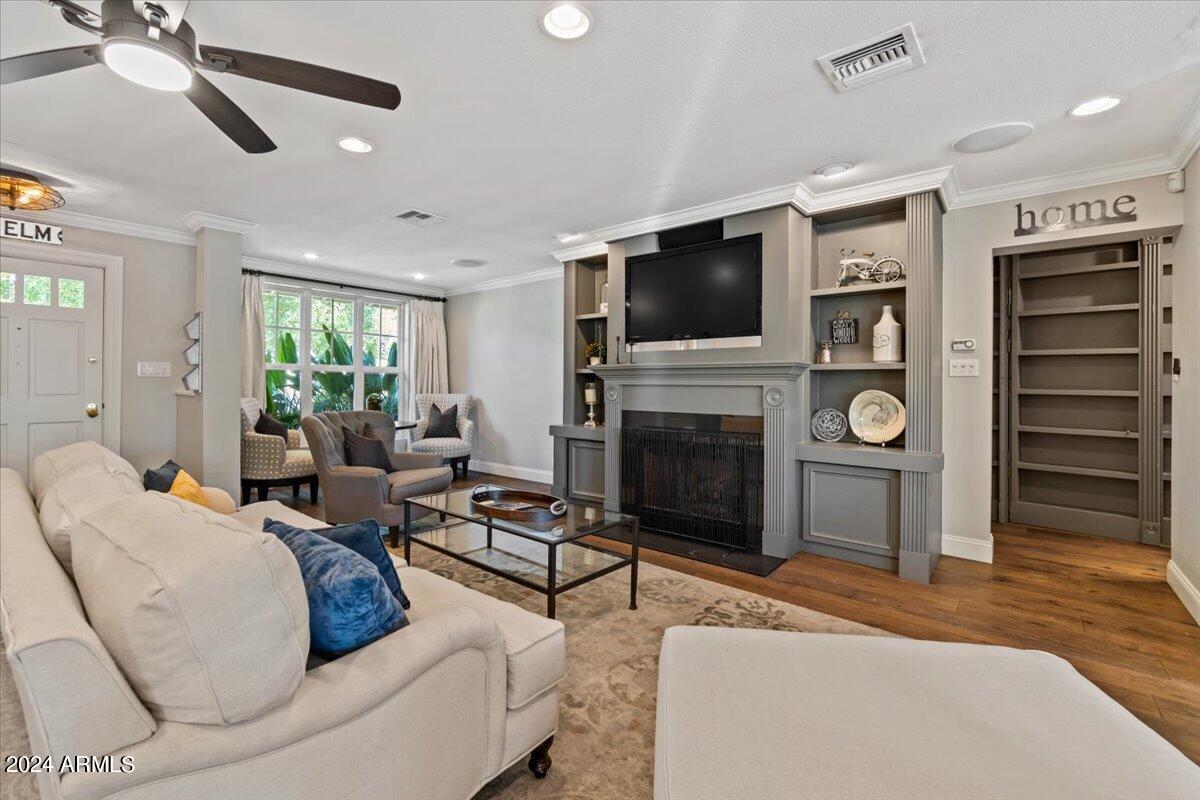 3841 East Elm Street Phoenix, AZ 85018 - Photo 14 of 72 a living room with furniture a flat screen tv and a fireplace