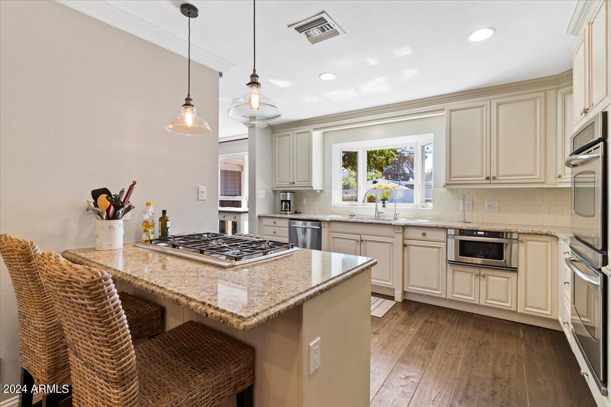 3841 East Elm Street Phoenix, AZ 85018 - Photo 20 of 72 a kitchen with stainless steel appliances granite countertop a stove and a sink