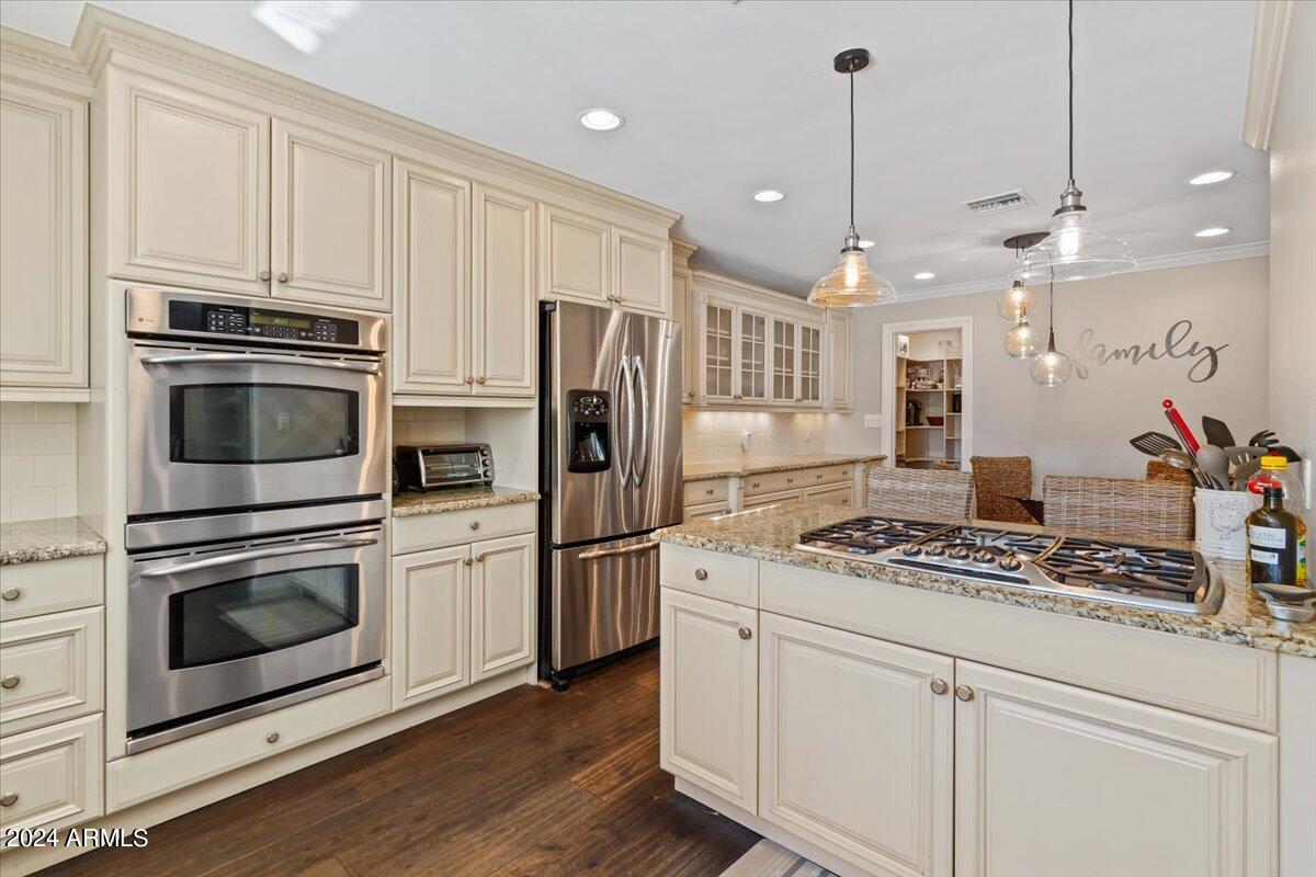 3841 East Elm Street Phoenix, AZ 85018 - Photo 22 of 72 a kitchen with stainless steel appliances white cabinets a stove a sink and refrigerator