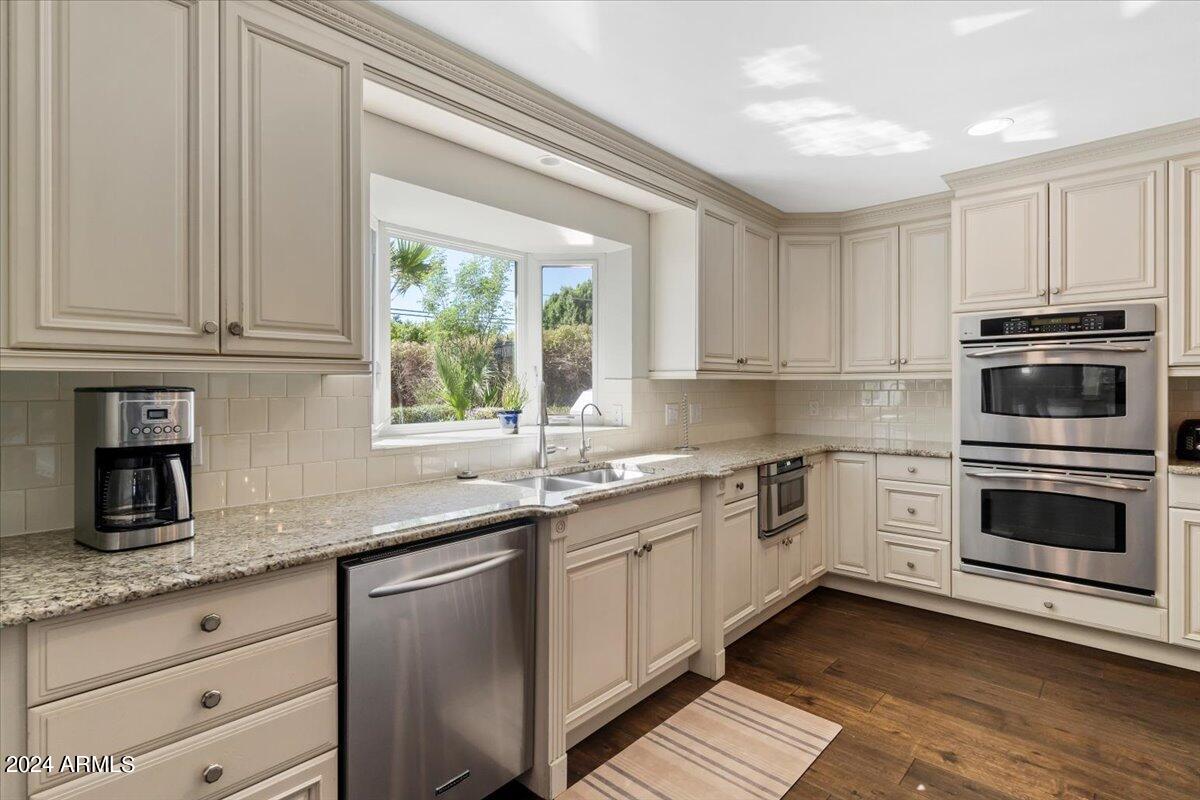3841 East Elm Street Phoenix, AZ 85018 - Photo 23 of 72 a kitchen with granite countertop a sink stainless steel appliances and cabinets
