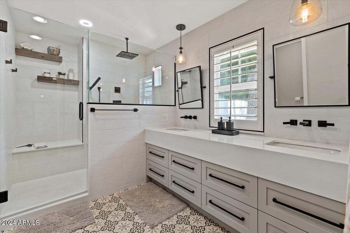 3841 East Elm Street Phoenix, AZ 85018 - Photo 30 of 72 a bathroom with a double vanity sink a mirror and a shower
