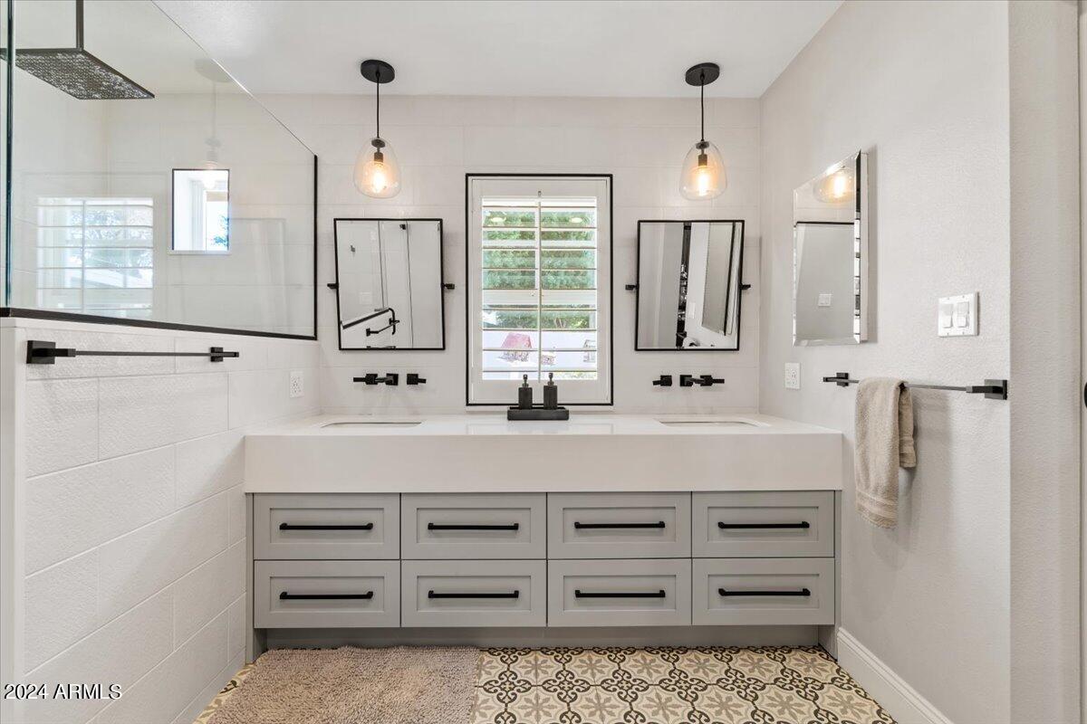3841 East Elm Street Phoenix, AZ 85018 - Photo 31 of 72 a bathroom with a sink a mirror a vanity and a shower