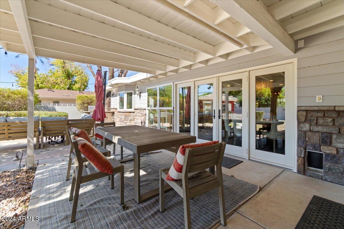 3841 East Elm Street Phoenix, AZ 85018 - Photo 44 of 72 a view of a patio with a dining table and chairs