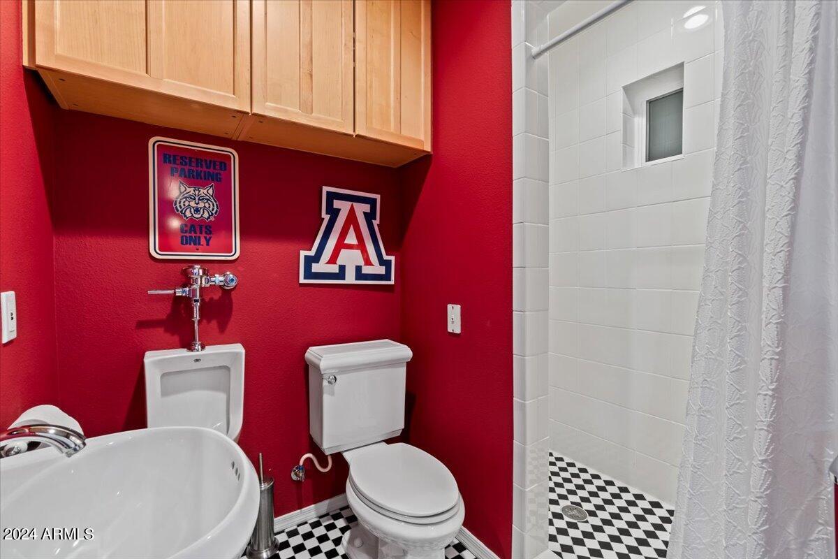 3841 East Elm Street Phoenix, AZ 85018 - Photo 56 of 72 a white toilet sitting next to a bathroom sink and vanity