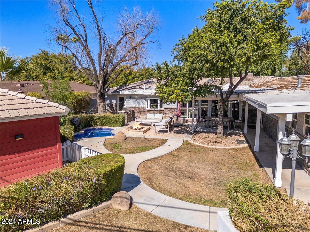 3841 East Elm Street Phoenix, AZ 85018 - Photo 67 of 72 a view of the patio with couches and table and chairs under an umbrella
