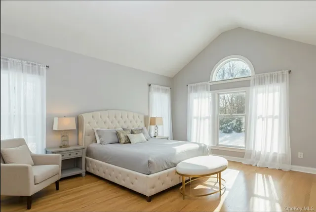 a spacious bedroom with a bed and a large window